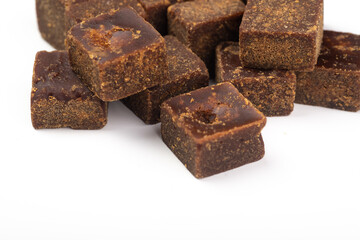 Lumpy brown sugar on a white background