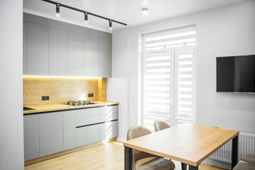 Light modern kitchen interior with gray tones. Cozy home.