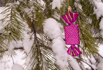 a christmas toy on a snowy branch