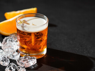 Fragrant gel candle in a glass with orange slices.