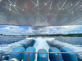 The back of a fast boat that is moving. The roar of the waves from behind the fast boat