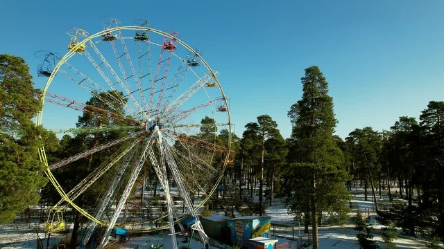 Empty Ferris wheel in the park in winter. Aerial.