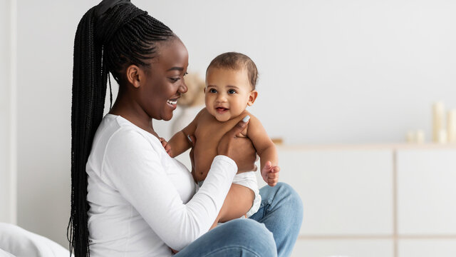 Black woman playing with her cute little infant, banner