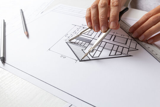 Architectural drawing of a house on a designer's desktop. Blueprints.