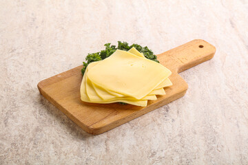 Sliced Gouda cheese over board