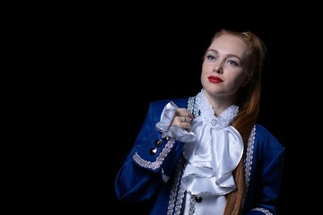 beautiful girl posing in a butler costume on a black background