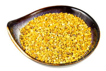 ceramic bowl with natural bee pollen isolated on white background
