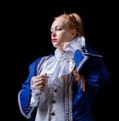 beautiful girl posing in a butler costume on a black background