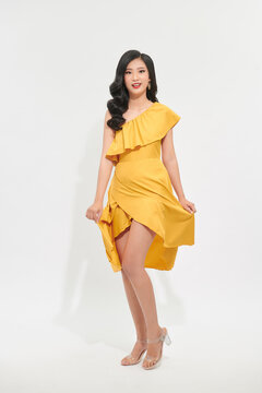 beautiful asian women swirling with happiness, in pretty yellow dress