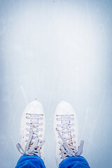 abstract light blue ice surface with imprints from figure skates with skates