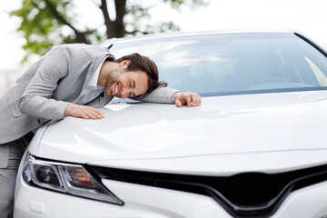 Dreams come true today. Happy handsome businessman buying car at dealership