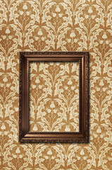 empty picture frame hang on a vintage wallpaper
