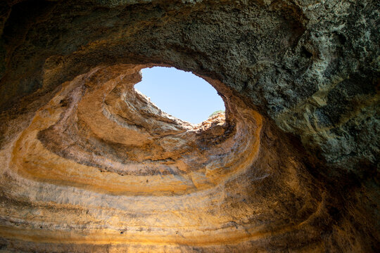 Heart shaped opening in caves of Algarve, Portugal, Europe view from popular boat cave tour along Algarve coast. Marinha Beach is one of the most beautiful beaches in the world.