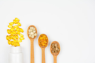 A variety of dietary supplements and vitamin pills on white background