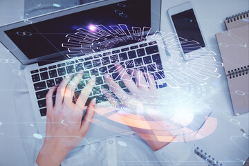 Double exposure of woman hands working on computer and data theme hologram drawing. Top View. Technology concept.
