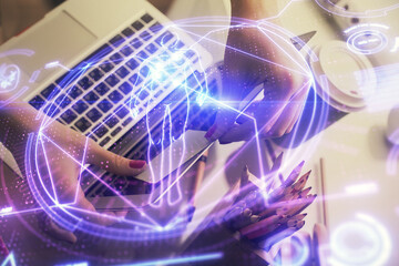 Double exposure of woman hands typing on computer and general theme hologram drawing. Education concept.