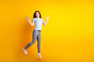 Full body profile side photo of young impressed lady jump active news isolated over yellow color background