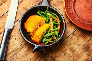 Chicken cutlets and vegetable garnish.