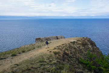Fototapeta na wymiar Hiker on the cliff of the Olkhon island