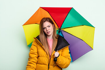redhair woman feeling puzzled and confused. umbrella concept