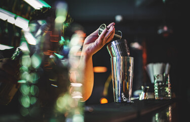man hand bartender making cocktail in bar with shaker