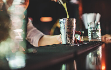 man hand bartender making cocktail in bar with shaker