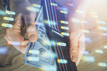 Double exposure of technology drawing hologram and us dollars bills and man hands. Data concept