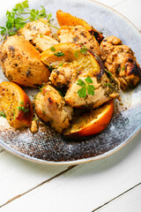 Pieces of chicken fillet in oranges.