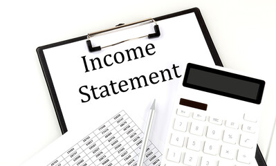 INCOME STATEMENT text on folder with chart and calculator on the white background