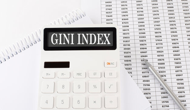 Calculator with text GINI INDEX on the notebook . Business, finance conceptual.