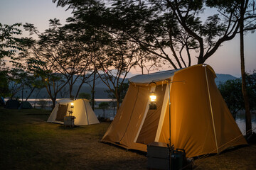 Camping tent on campsite with panoramic view in evening sunset. cozy tents for recreation near...