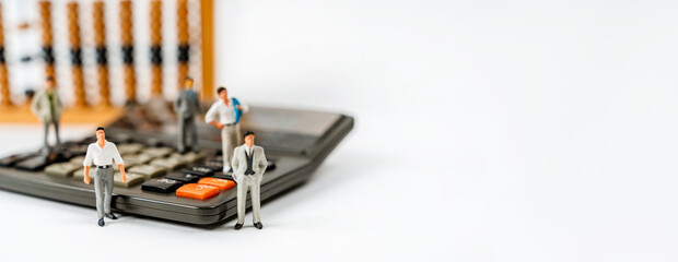 Miniature figures of businessmen stand on wooden accounts to calculate profits. The concept of business and making money