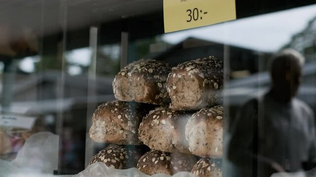 Loaf of bread on sale in display window breads bakery baker restaurant caf&eacute; soup shop cheap toast toasters wheat corn fullcorn fiber sandwich sandwiches healthy cozy market marketplace store shopping