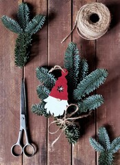 Flatlay with nobilis fir branches, old scissors, skein of twine and christmas decoration of...