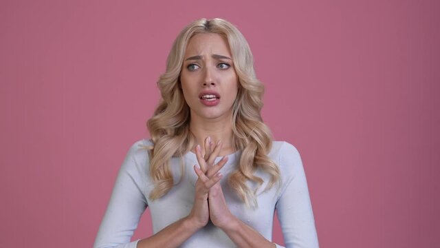 Afraid lady cross fingers gesture ask plead isolated pastel color background