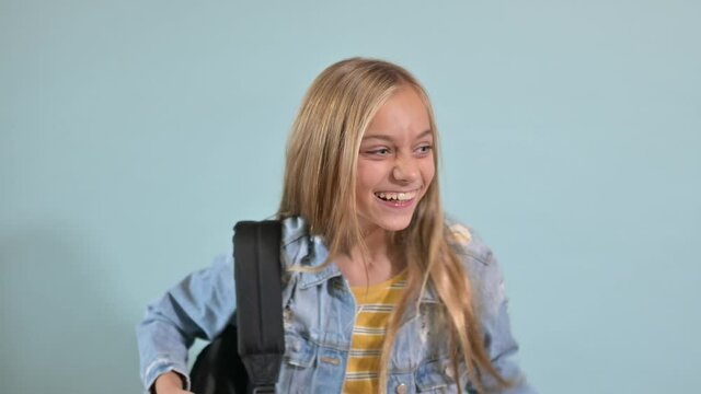 Teen girl making humorous gestures to the camera.