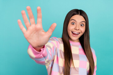 Photo of adorable funky school girl dressed prink pullover waving arm isolated teal color background