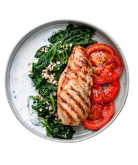Fried chicken fillet with Greek dzadziki sauce and stewed spinach. Top view