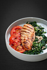 Fried chicken fillet with Greek dzadziki sauce and stewed spinach.