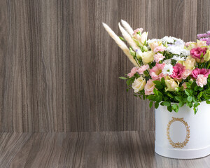 Modern floral arrangement in a round box
