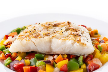 Grilled cod with vegetables in plate isolated on white background.Close up
