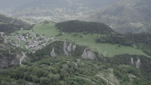panning video moving forward with drone over the aosta valley in saint nicolas with the church of fonfo and over a winding road