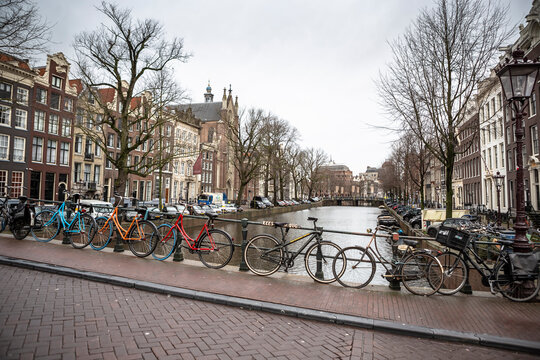 Bicycle parked on bridge above canal in central Amsterdam Netherlands © Sergey Kelin