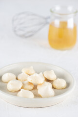 Aquafaba meringue on a plate on a light table. Sugar, lactose free, vegan dessert.