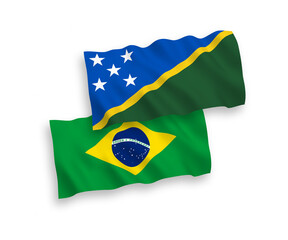 National vector fabric wave flags of Brazil and Solomon Islands isolated on white background. 1 to 2 proportion.