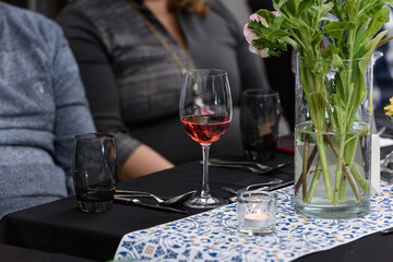 Glass of red wine on a served table in a restaurant