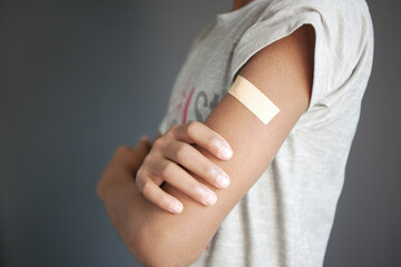 adhesive bandage on young man's arm 