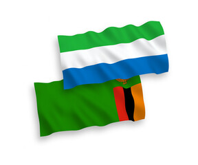 National vector fabric wave flags of Republic of Zambia and Sierra Leone isolated on white background. 1 to 2 proportion.