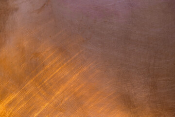 Copper reflects sunlight. The texture of a copper plate.