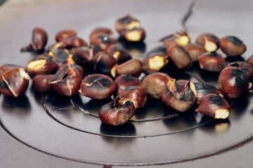 Roasted chestnuts on a traditional wood-fired iron stove. Typical food of the winters in the north of Spain. Chestnuts are reminiscent of autumn and winter